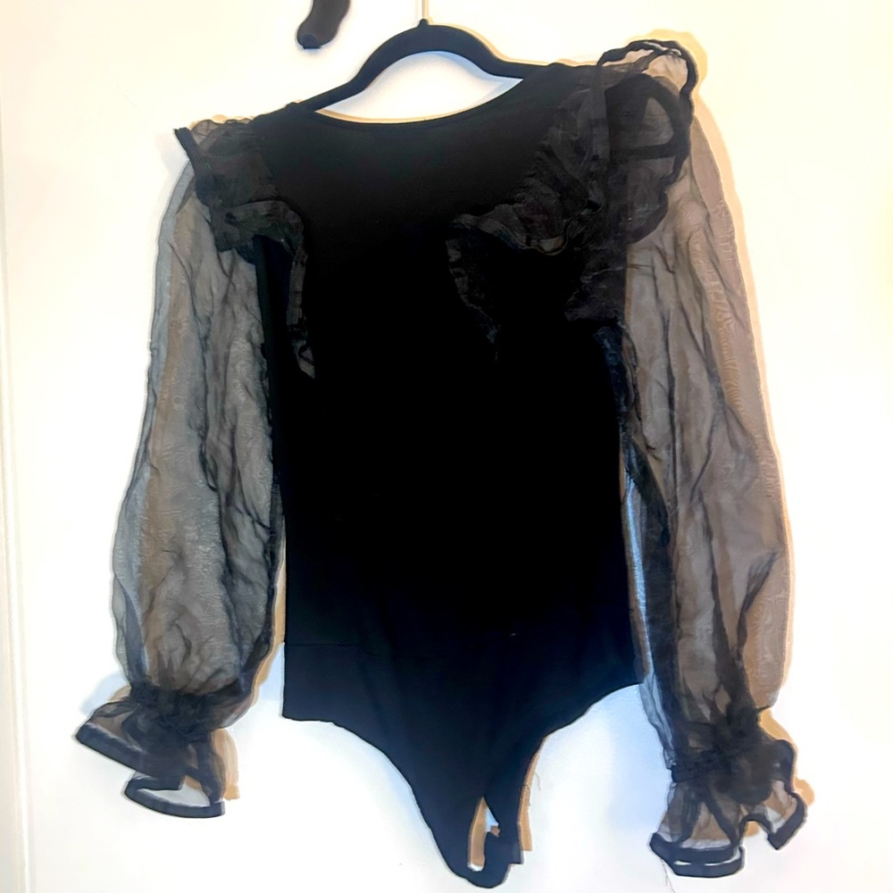 Black v-neck bodysuit with ruffled sheer sleeves